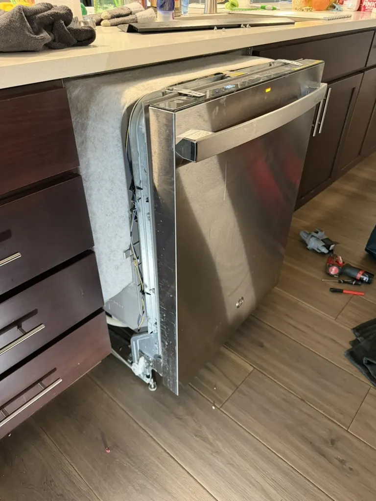 Dishwasher safely pulled from cabinetry for professional drain-system inspection