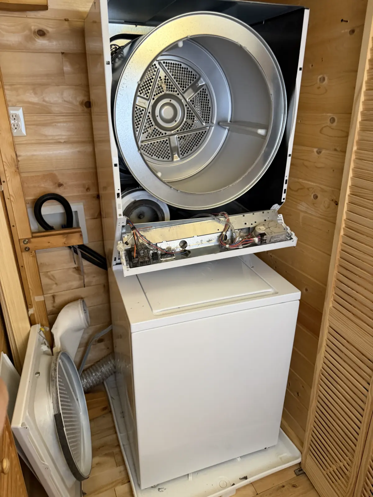 Conventional dryer opened for diagnosis with the drum and control panel accessible