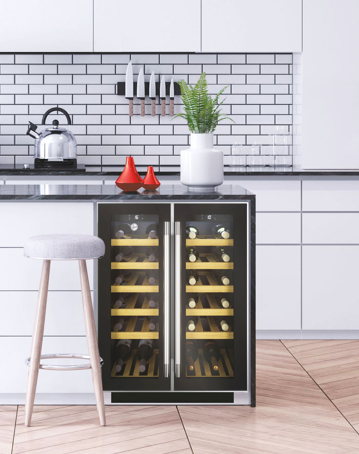 Built-in glass-door wine cooler filled with wine bottles